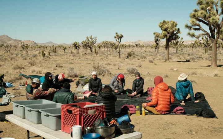 a group of people sit at camp in Joshua Tree National Park